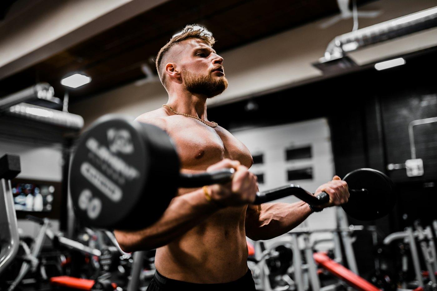 Athlete curling a barbell